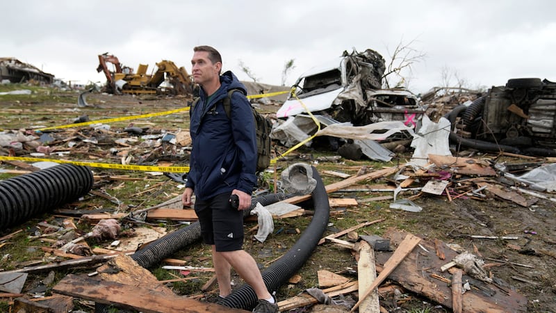 Brian Gutmann, of Creston, Iowa, looks over tornado-damaged property, Tuesday, May 21, 2024,...
