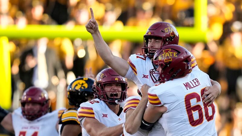 Iowa State place kicker Kyle Konrardy (97) celebrates with teammate Tyler Miller (66) after...