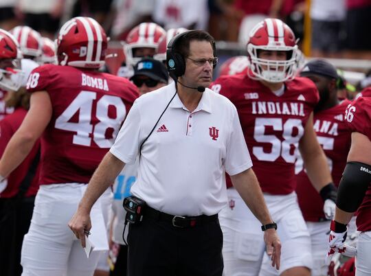 Indiana head coach Curt Cignetti, center, watches the first half of an NCAA college football...