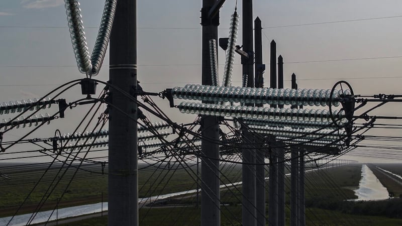 WEST PALM BEACH, FLORIDA - MAY 16: In an aerial view, high voltage power lines run along the...