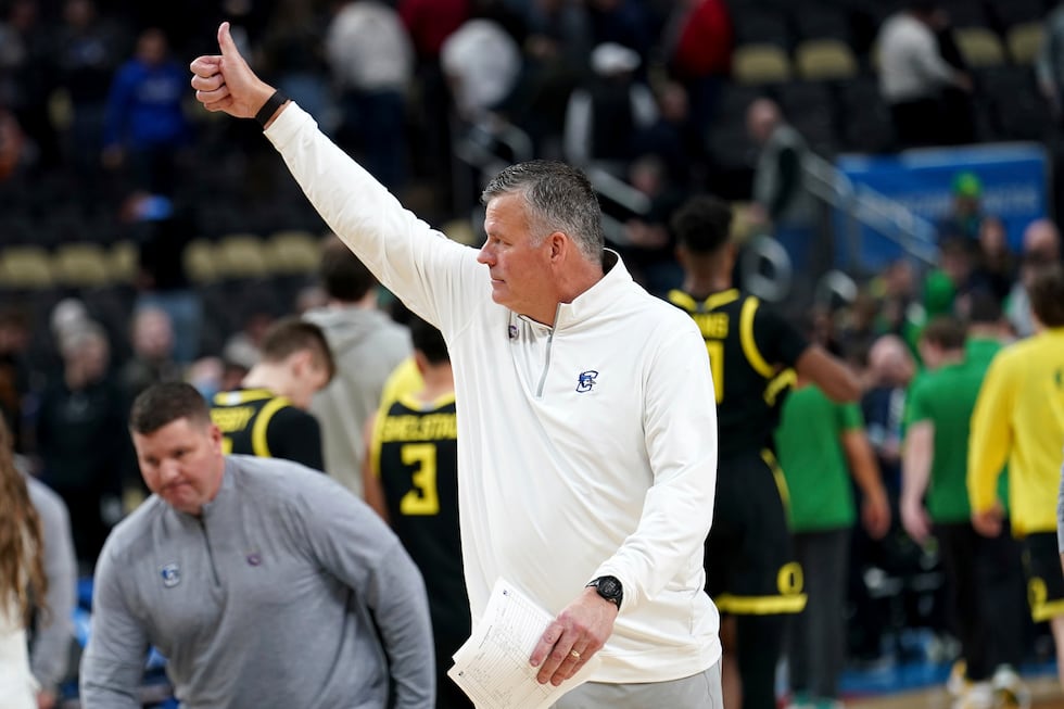 Creighton head coach Greg McDermott gestures to the crowd after defeating Oregon in a college...