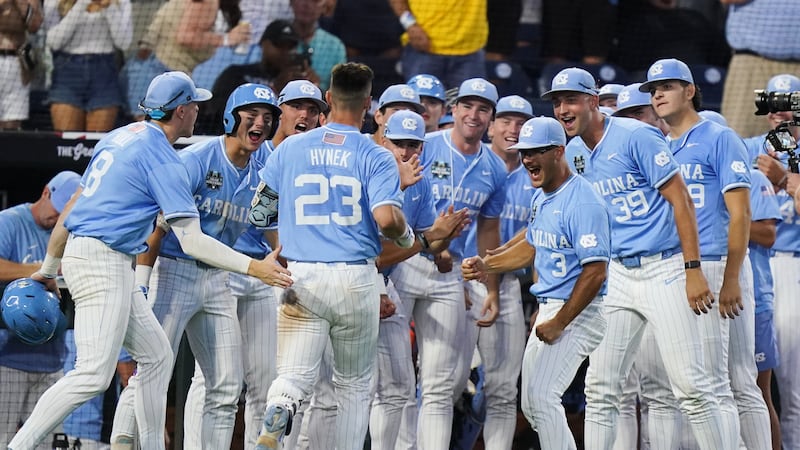North Carolina catcher Colin Hynek (23) celebrates with teammates after hitting a homer during...