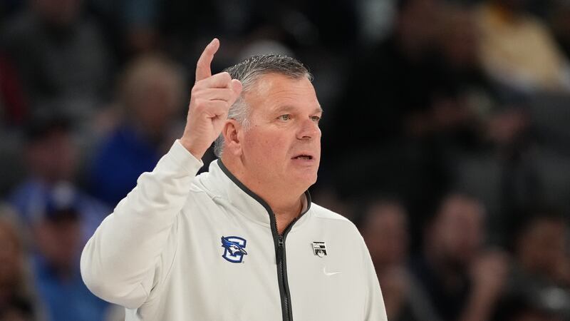 Creighton head coach Greg McDermott signals to his players during the first half of an NCAA...