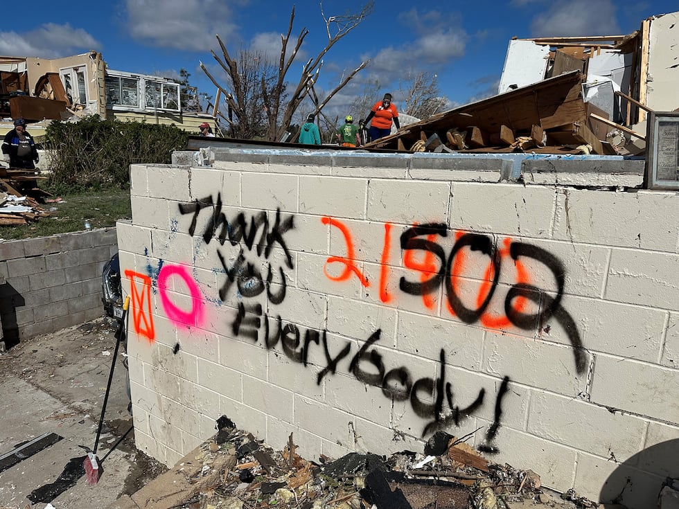 "Thank you everybody" is seend spray painted on a damaged home Monday in Elkhorn. The area was...