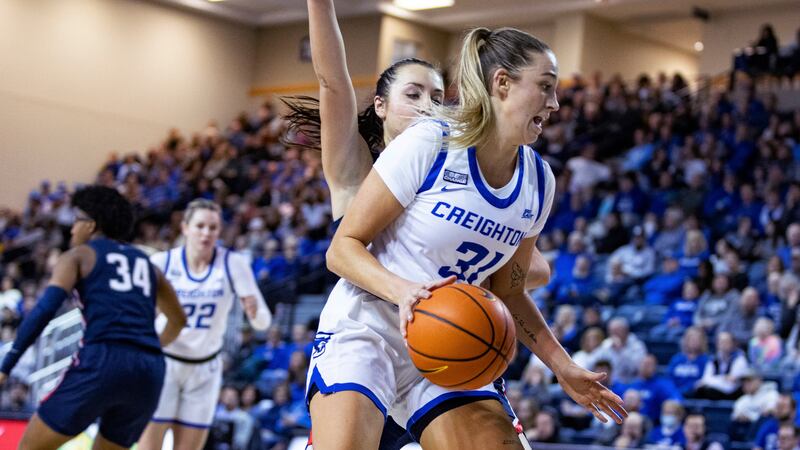 Creighton's Emma Ronsiek (31) drives to the basket against UConn's Nika Muhl, behind, during...