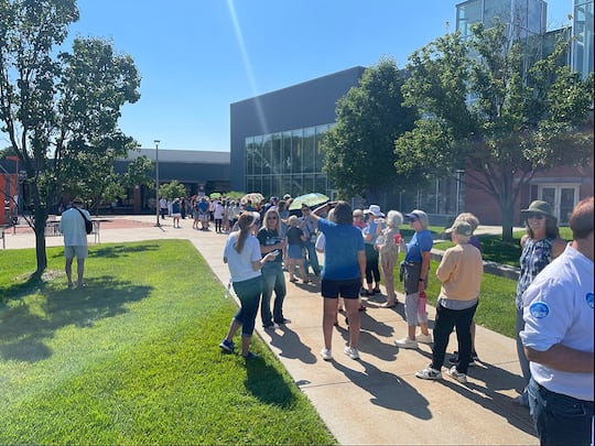 People wait to get into a Democratic event featuring former U.S. Transportation Secretary Pete...