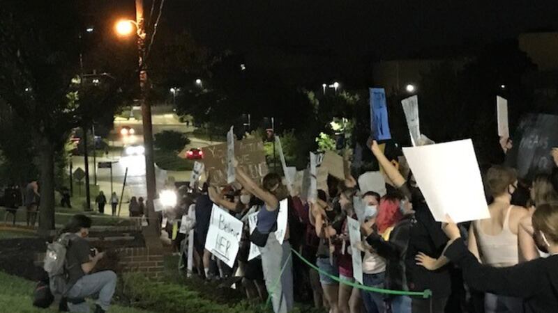 KU Students gather outside the Phi Kappa Psi Tuesday night to protest the alleged rape by one...