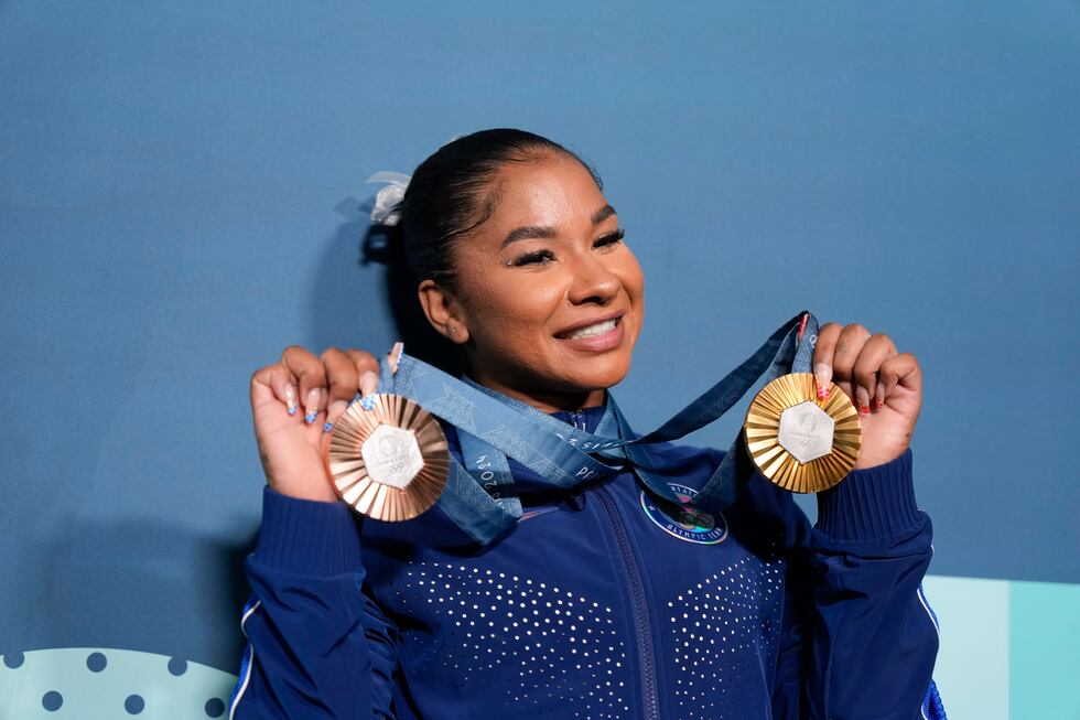 Jordan Chiles, of the United States, holds up her medals after the women's artistic gymnastics...