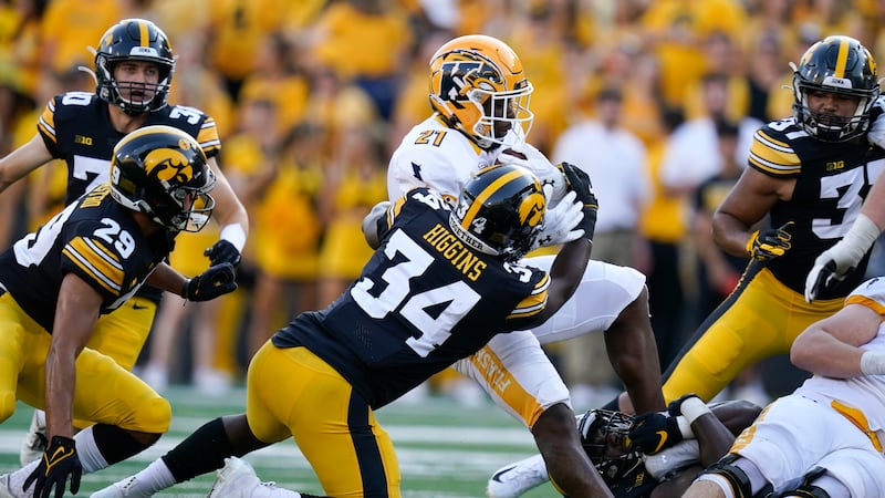 FILE - Kent State running back Joachim Bangda (21) is tackled by Iowa linebacker Jay Higgins...