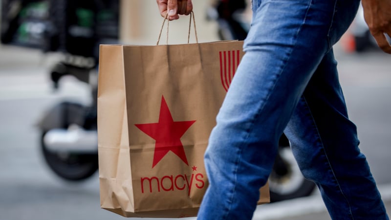 A shopper carries a Macy's bag through Union Square as retailers prepare for Black Friday in...