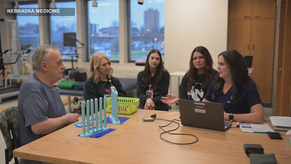 Mark Wilson's occupational therapy team at Nebraska Medicine turns on his Vivistim device for...