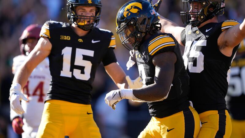 Iowa running back Kaleb Johnson (2) celebrates with teammates Reece Vander Zee (15) and Luke...