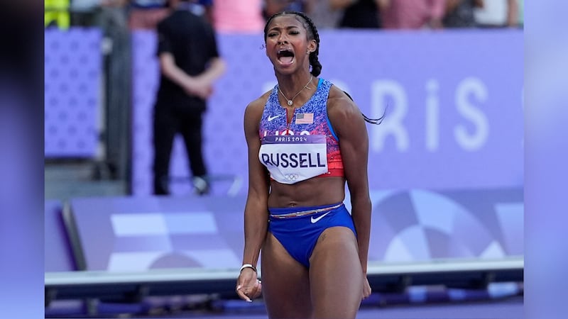 Masai Russell, of the United States, reacts after winning the women's 100-meter hurdles final...