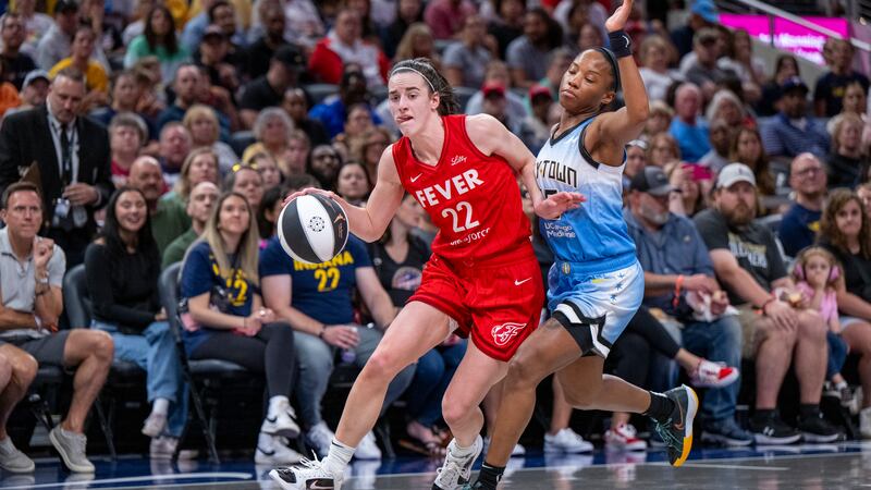 Indiana Fever guard Caitlin Clark (22) makes contact with Chicago Sky guard Lindsay Allen (15)...