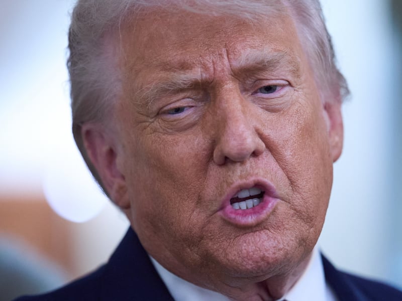 FILE -- President Donald Trump speaks with reporters aboard Air Force One after leaving the...