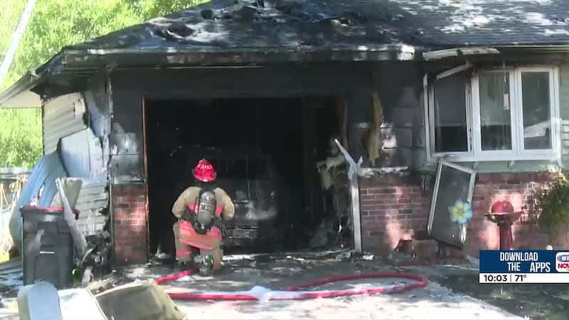 A car is destroyed after a garage fire in north Lincoln on Monday afternoon.